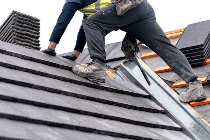 image of a roofer working on a roof